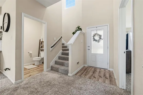 a view of entryway and hall with wooden floor