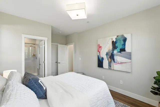 a bedroom with a bed and a painting on the wall