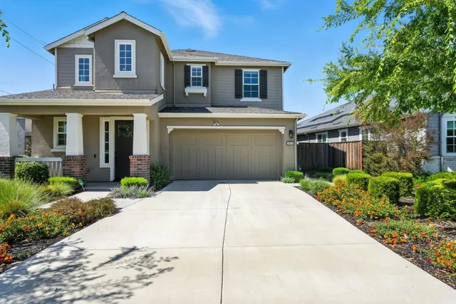 a front view of a house with a garden