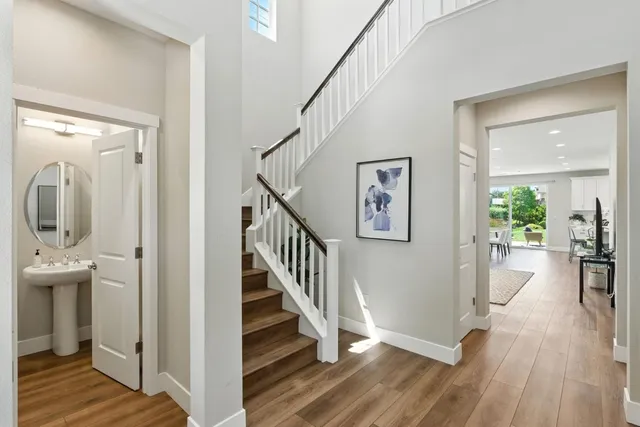 a view of entryway and hall with wooden floor
