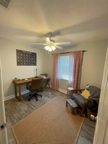 a living room with furniture a rug and a table