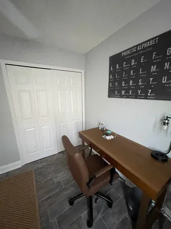 a view of a workspace with furniture