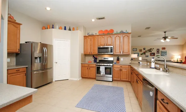 a kitchen with stainless steel appliances a refrigerator stove and sink
