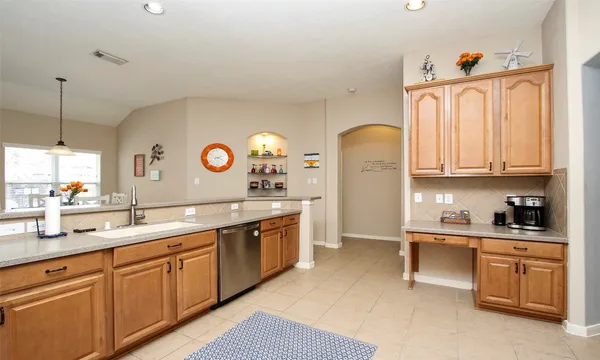 a kitchen with a sink a stove and cabinets