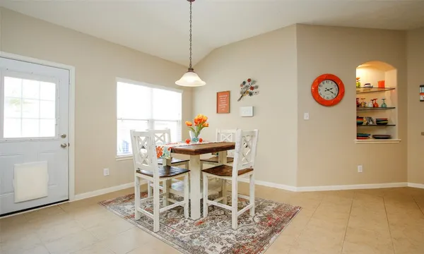 a view of a dining room with furniture and a window