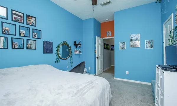 a bedroom with a bed and book shelf
