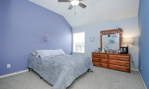 a bedroom with bed and window