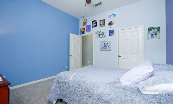 a bedroom with a bed and a white wall
