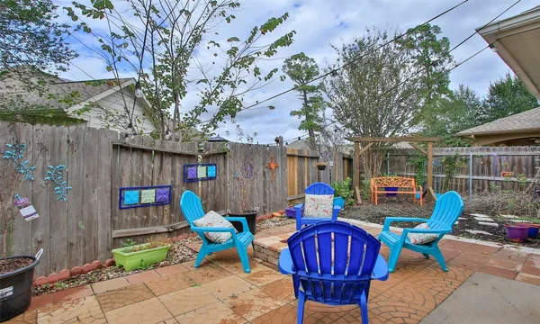 a view of outdoor sitting area with furniture and wooden fence