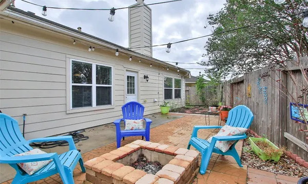 a view of house with backyard and sitting area
