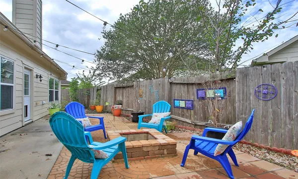 a backyard of a house with table and chairs