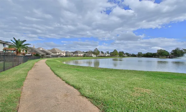 a view of a lake with houses in the back