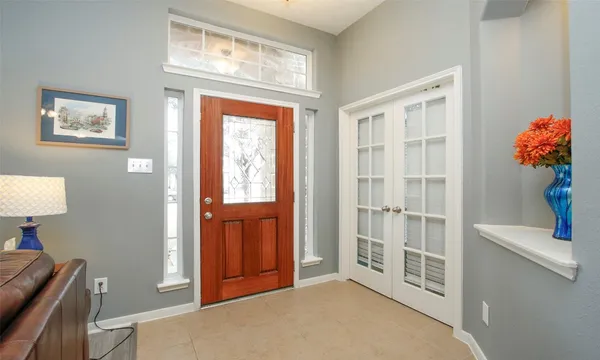 a view of an entryway with wooden floor and a bedroom