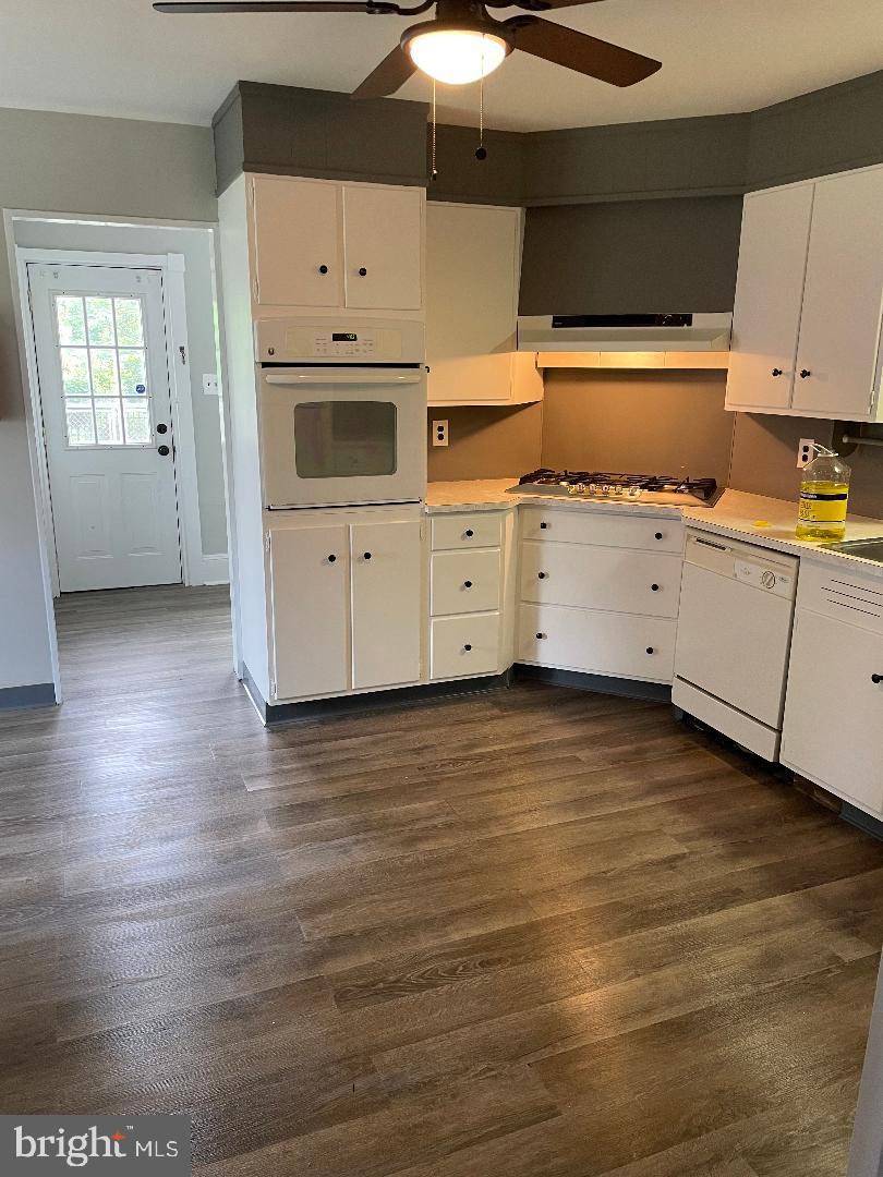 246 West Front Street Florence, NJ 08518 - Photo 4 of 9 a kitchen with wooden floors and white cabinets