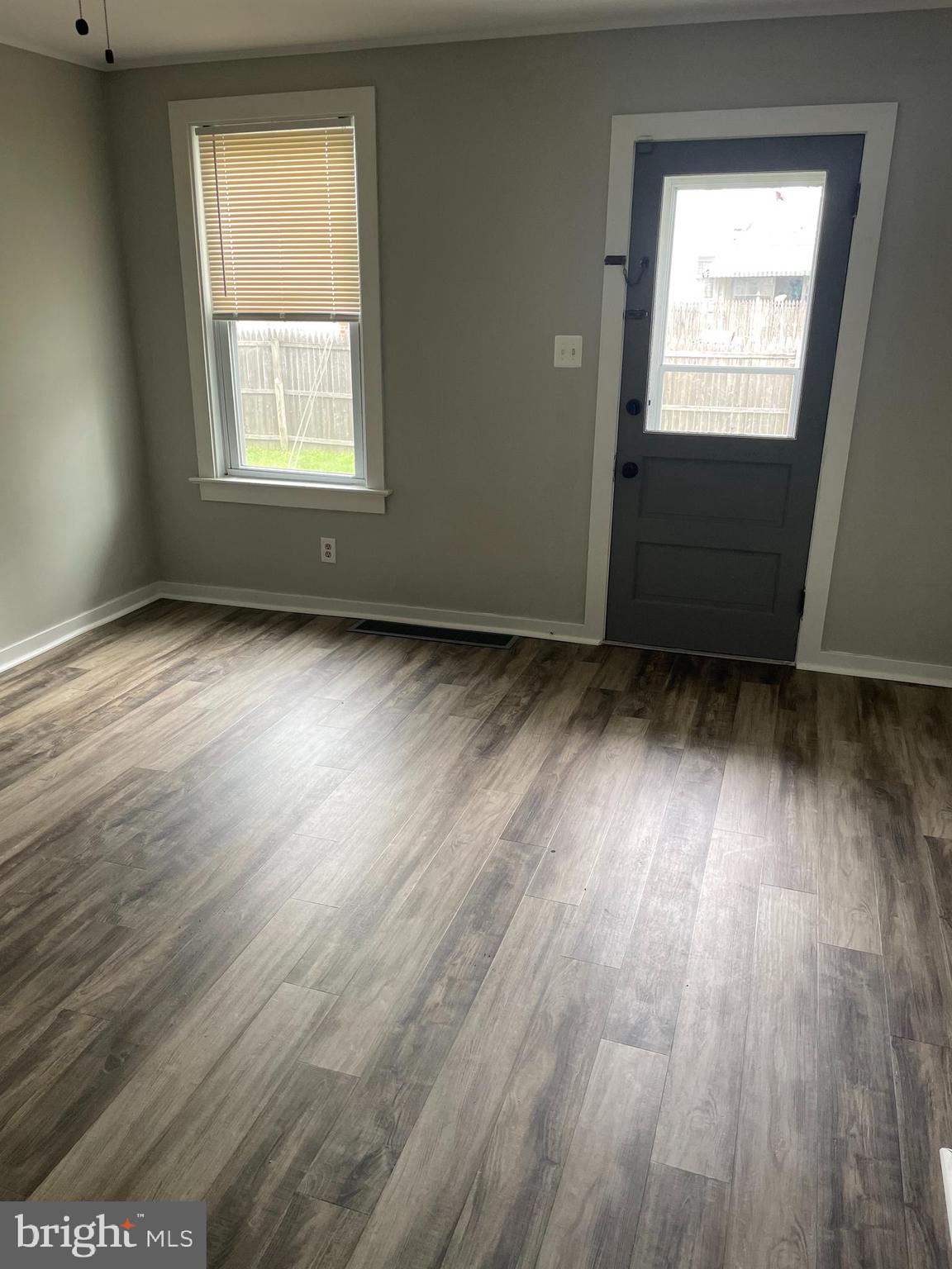 246 West Front Street Florence, NJ 08518 - Photo 7 of 9 an empty room with wooden floor and windows