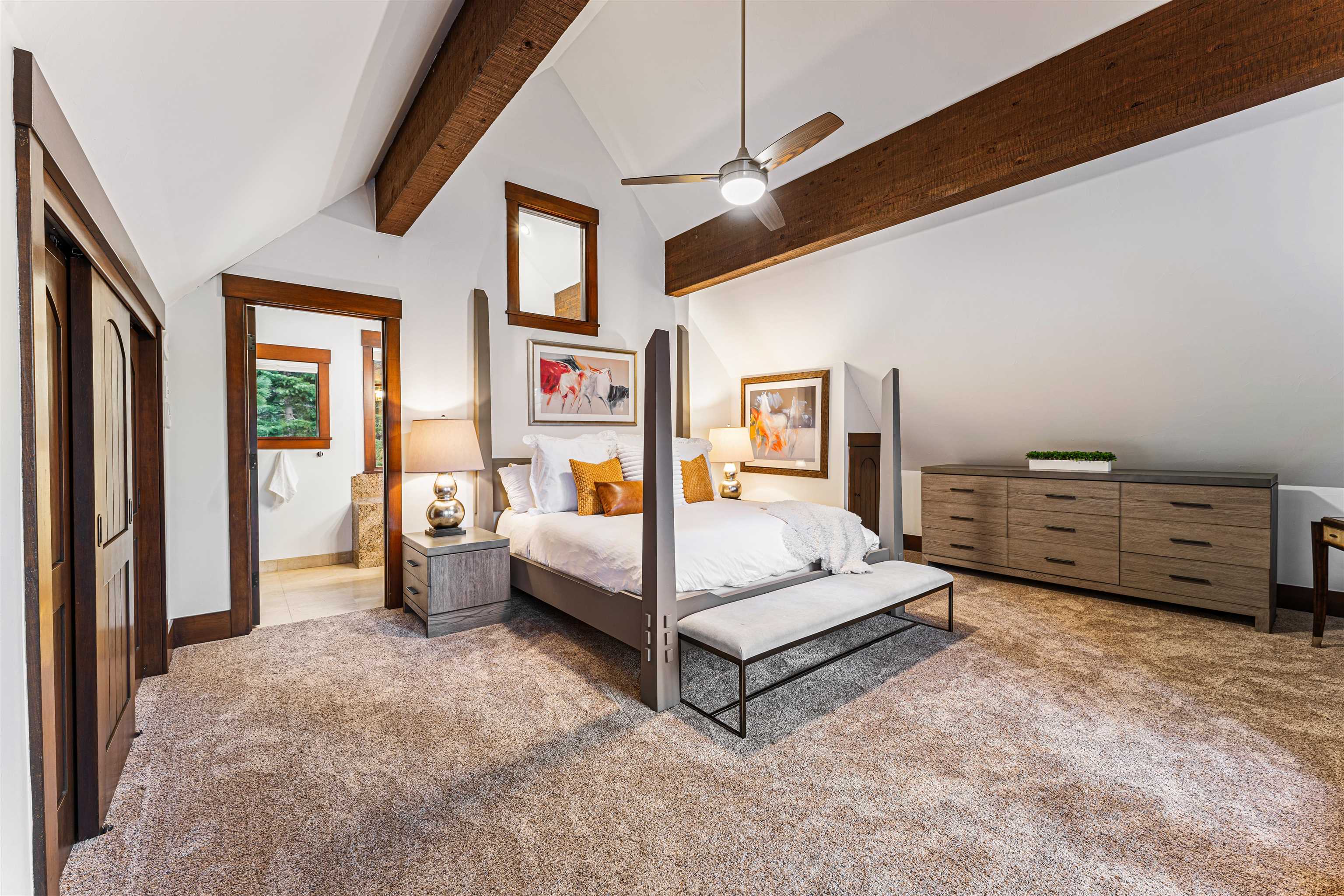 123 Dave Dysart Truckee, CA 96161 - Photo 18 of 28 a spacious bedroom with a bed and a ceiling fan