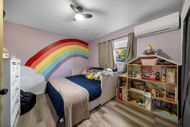 a bedroom with bed and a window