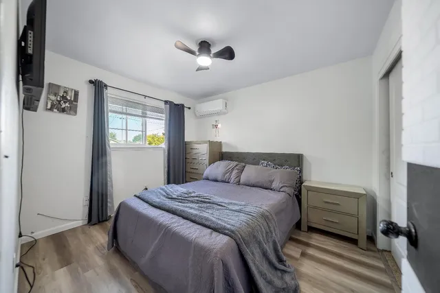 a bedroom with a bed and a window