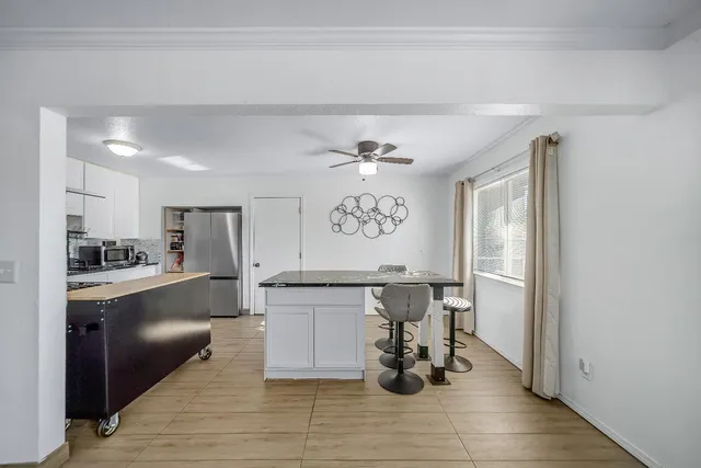 a large kitchen with a table and chairs