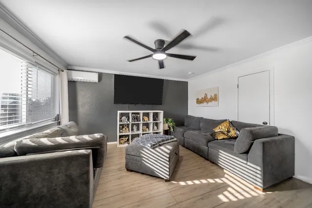 a living room with furniture and a flat screen tv
