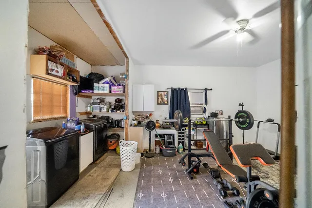 a view of a livingroom with workspace and a window