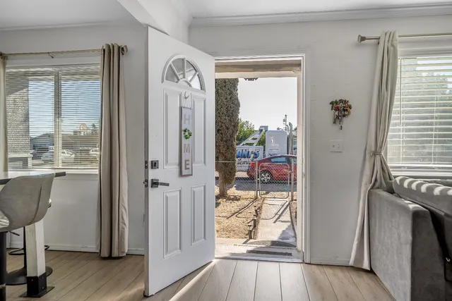 a very nice looking room with a large window and wooden floor