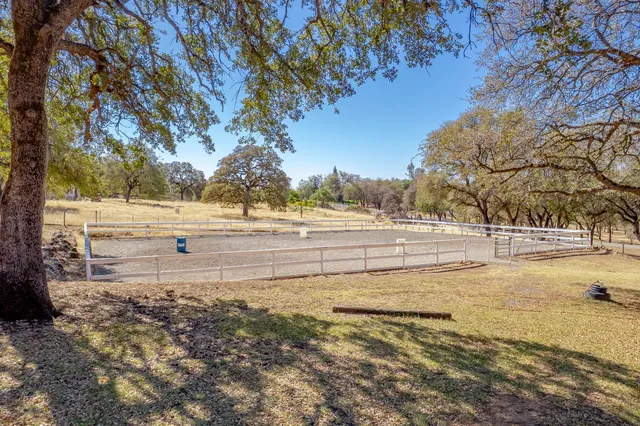a front view of a house with a yard table and chairs