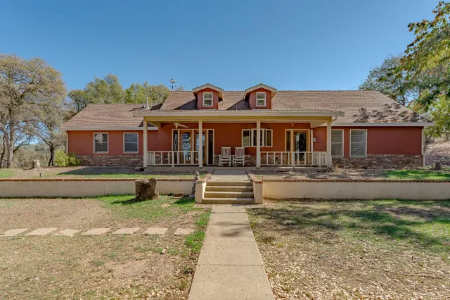 a front view of a house with a garden