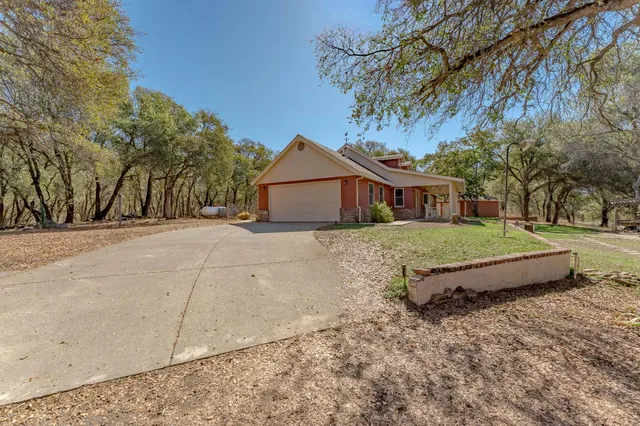 a view of an empty room with closet and a window