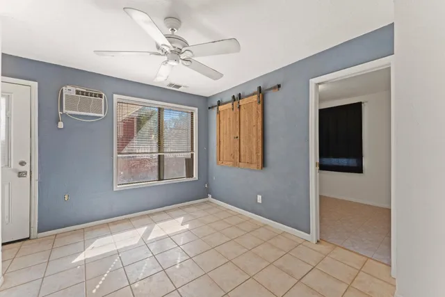 a view of backyard with wooden fence and a large tree