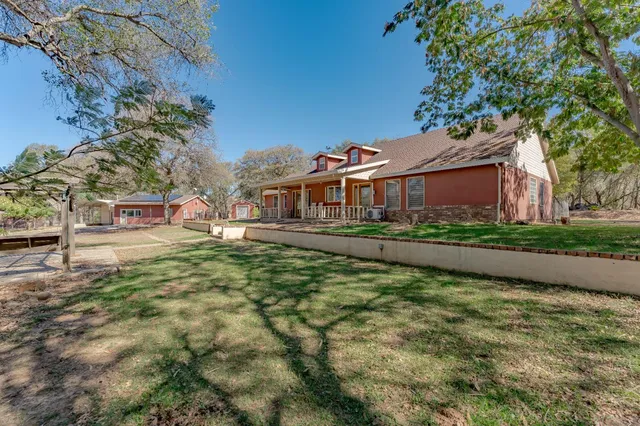 a view of a porch with furniture and a yard