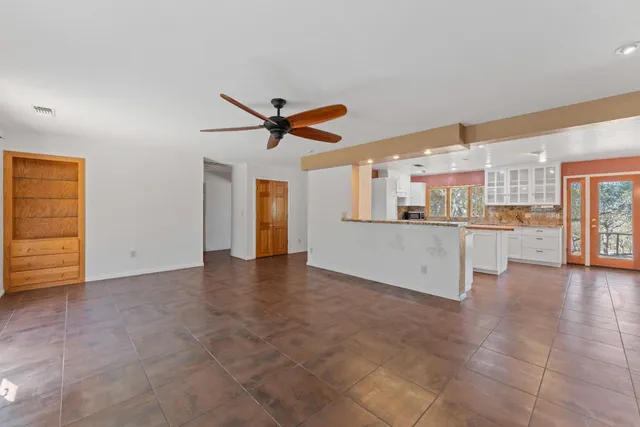 a kitchen that has a sink a stove and a table in it