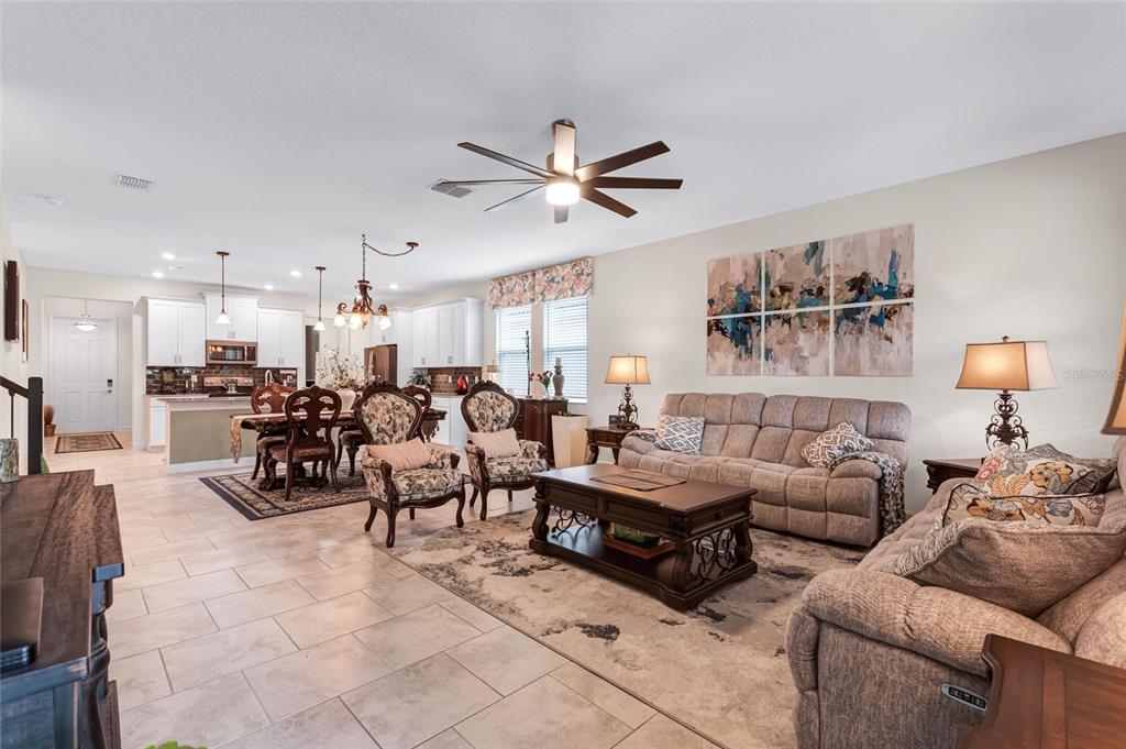 1089 Blackwolf Run Road Davenport, FL 33896 - Photo 17 of 82 a living room with furniture kitchen view and a chandelier