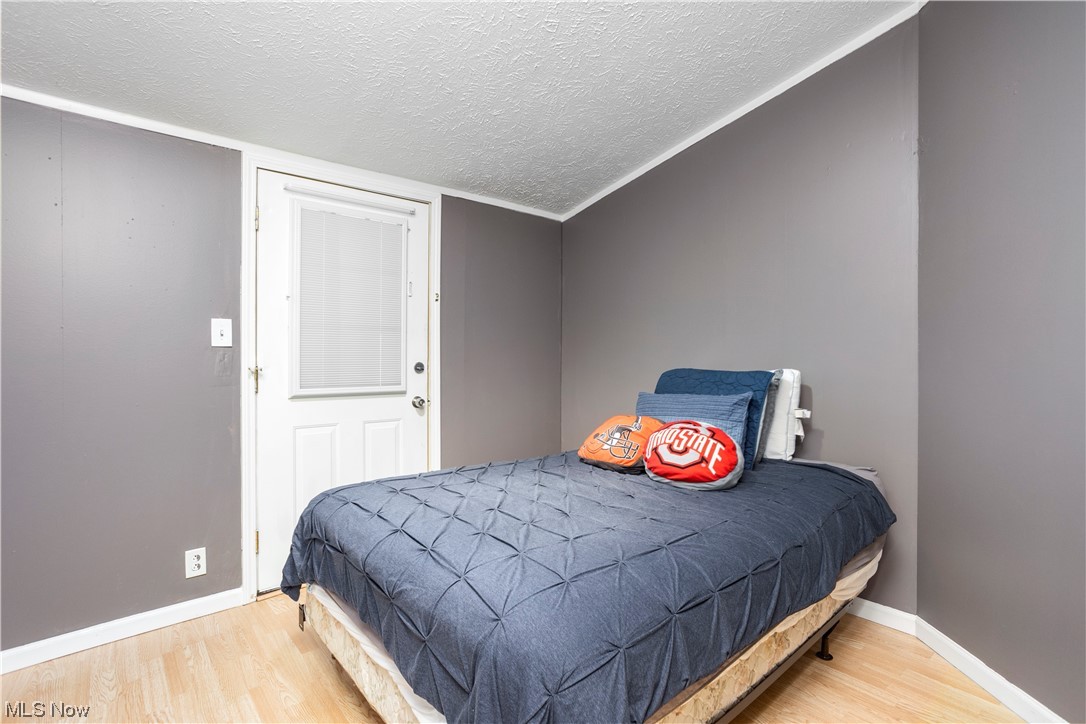 168 Coen Road Vermilion, OH 44089 - Photo 16 of 29 Hardwood floored bedroom featuring a textured ceiling
