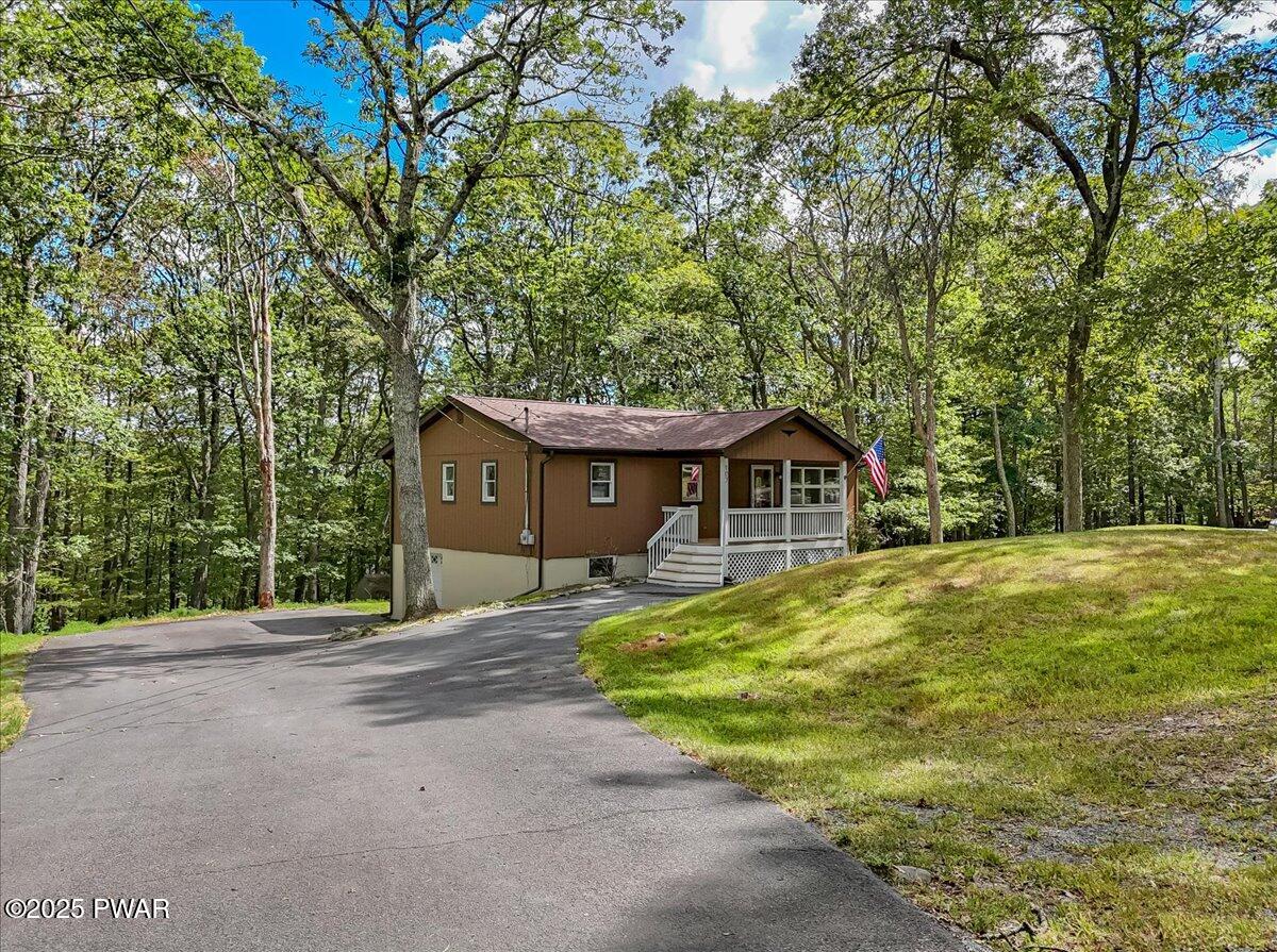 107 Kiel Road Milford, PA 18337 - Photo 6 of 71 a front view of a house with a garden