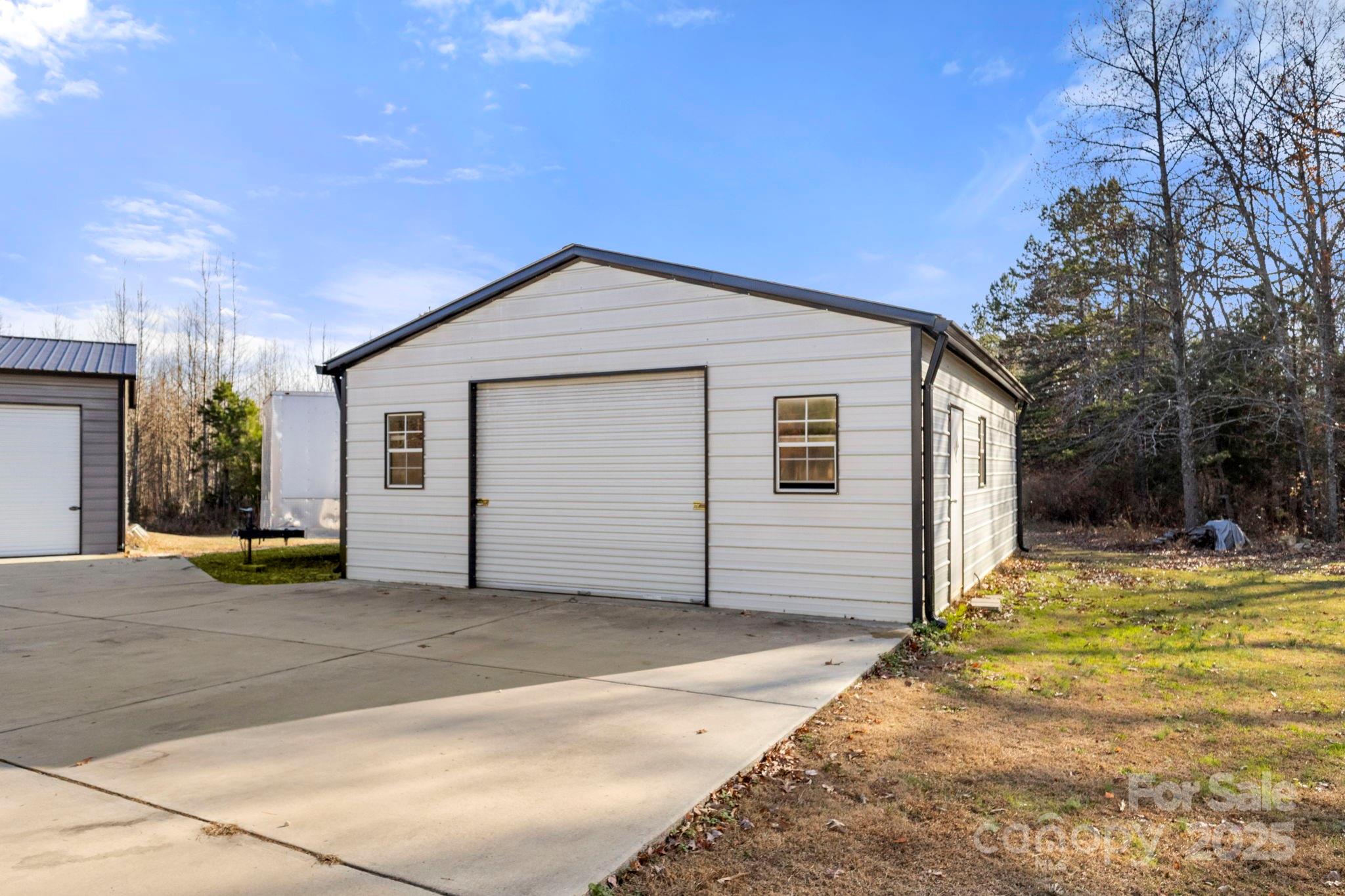 4290 Palmer Lloyd Road Lancaster, SC 29720 - Photo 17 of 48 a view of a house with a backyard and a garage