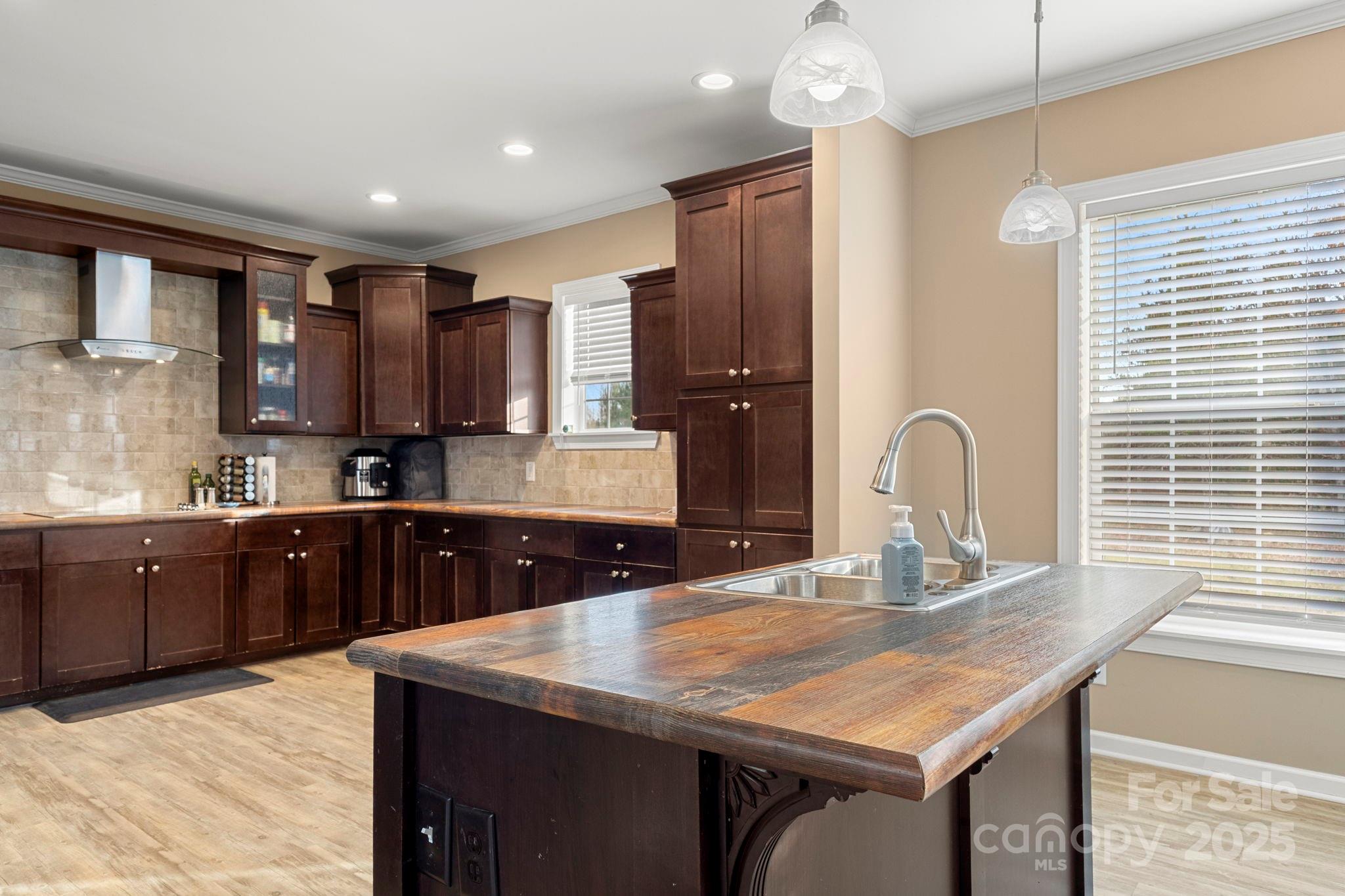 4290 Palmer Lloyd Road Lancaster, SC 29720 - Photo 25 of 48 a kitchen with kitchen island granite countertop a sink cabinets and window