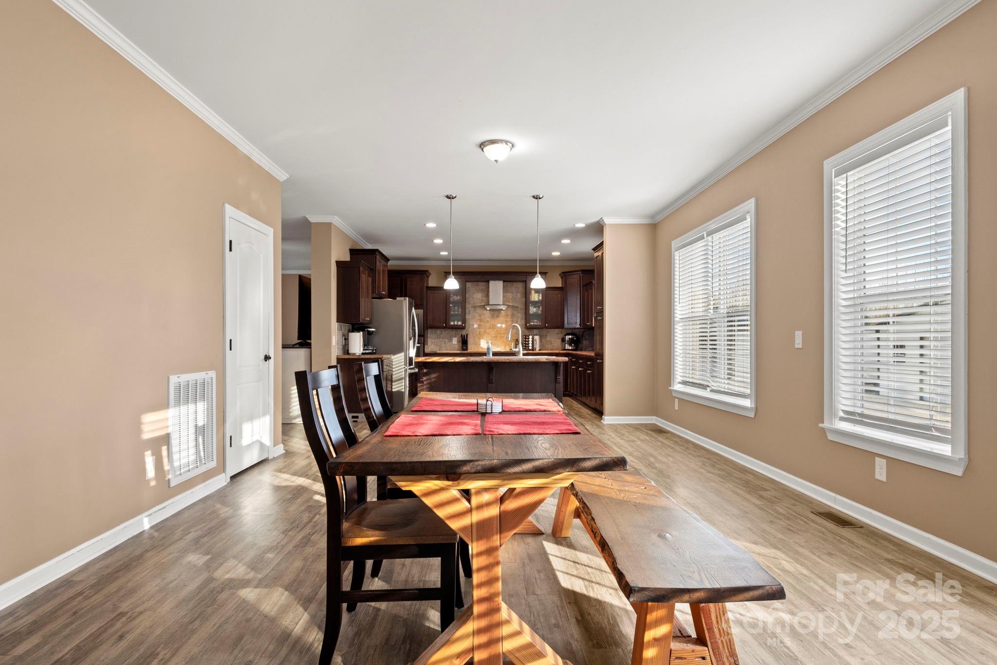 4290 Palmer Lloyd Road Lancaster, SC 29720 - Photo 31 of 48 a dining room with furniture and wooden floor