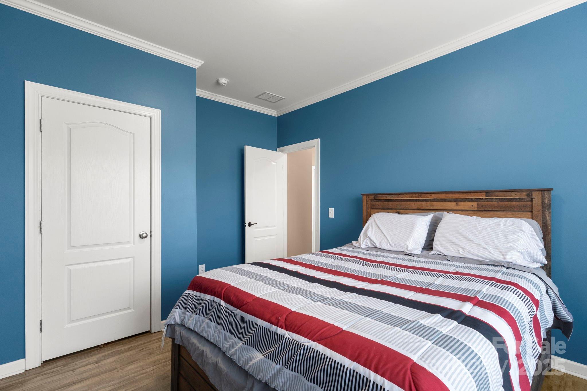 4290 Palmer Lloyd Road Lancaster, SC 29720 - Photo 37 of 48 a bedroom with a bed and wooden floor