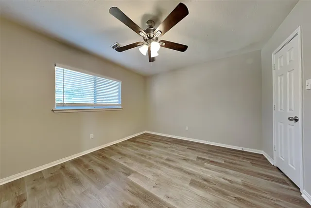 wooden floor in an empty room with a window