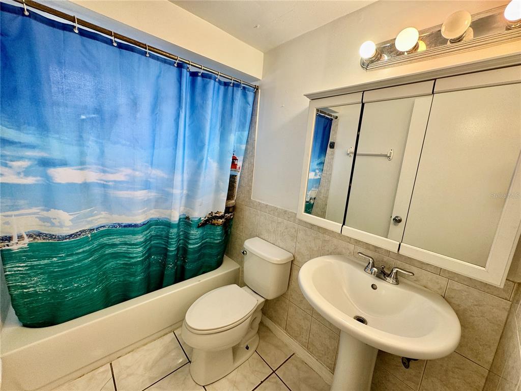 3049 Moog Road Holiday, FL 34691 - Photo 12 of 19 a bathroom with a sink a toilet and mirror