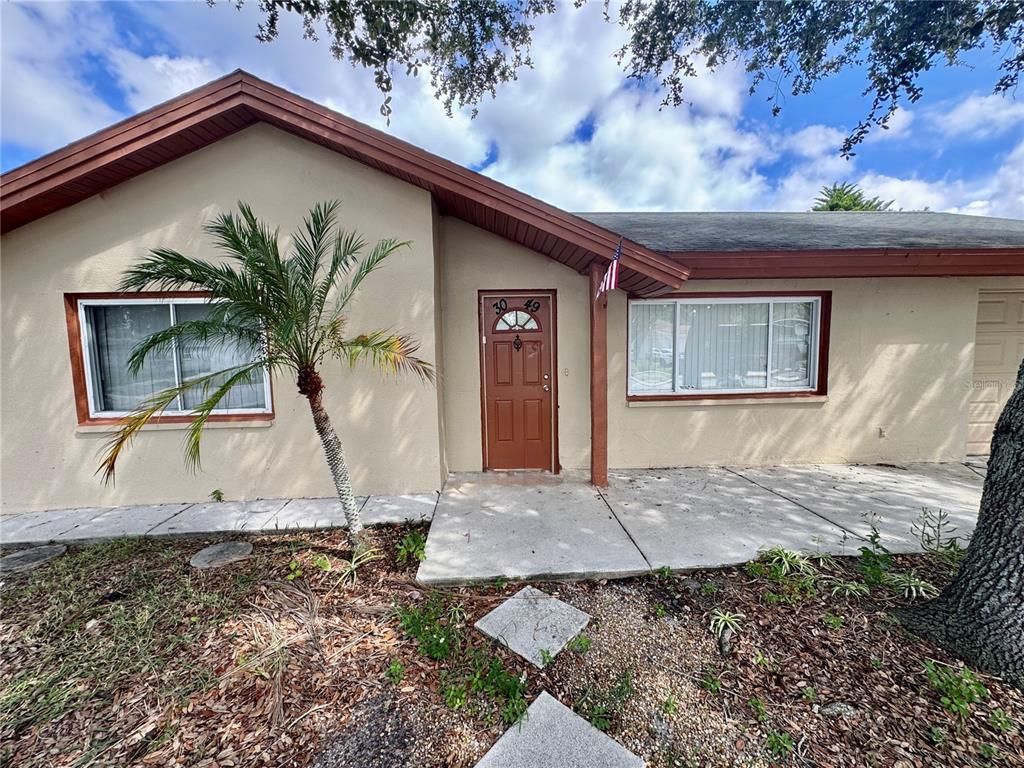 3049 Moog Road Holiday, FL 34691 - Photo 3 of 19 a view of front door and a yard