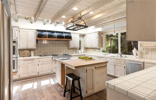 a kitchen with a sink stove and cabinets