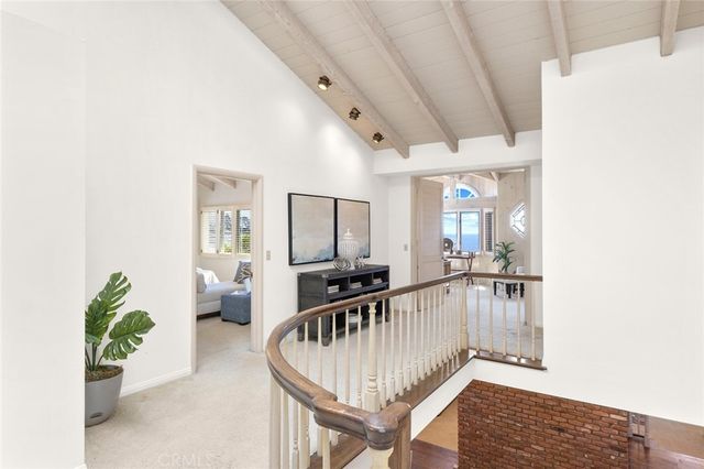a view of a hallway with dining area and chandelier