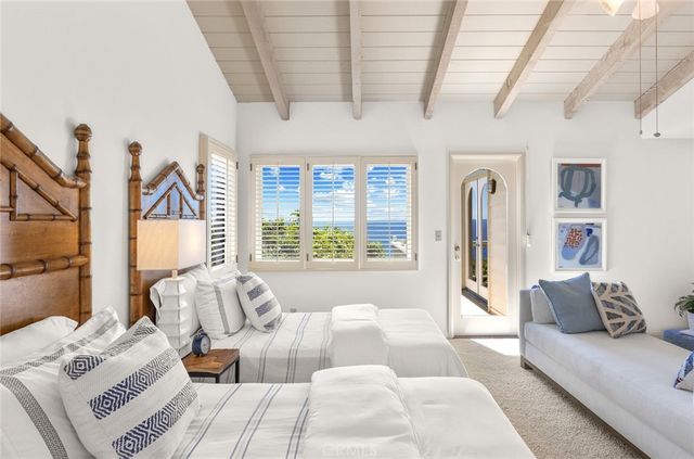 a bedroom with furniture and a large window