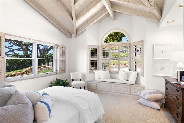 a bedroom with furniture and a large window