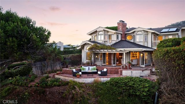 a front view of a house with yard and green space