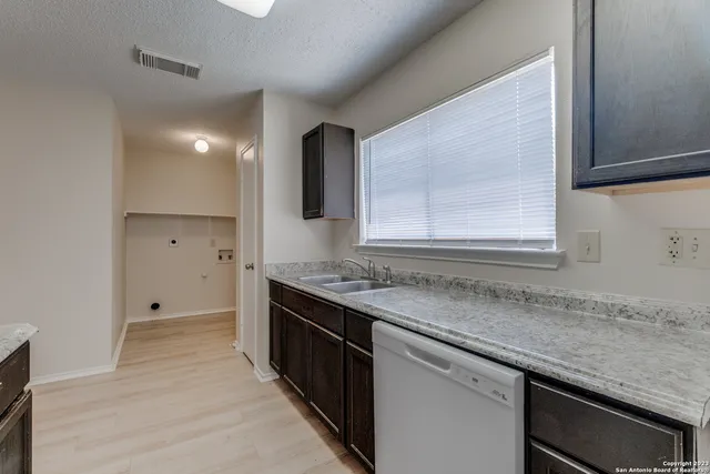 a kitchen with granite countertop a sink and a stove