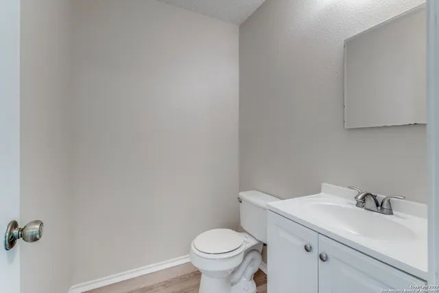 a white toilet sitting next to a bathroom sink