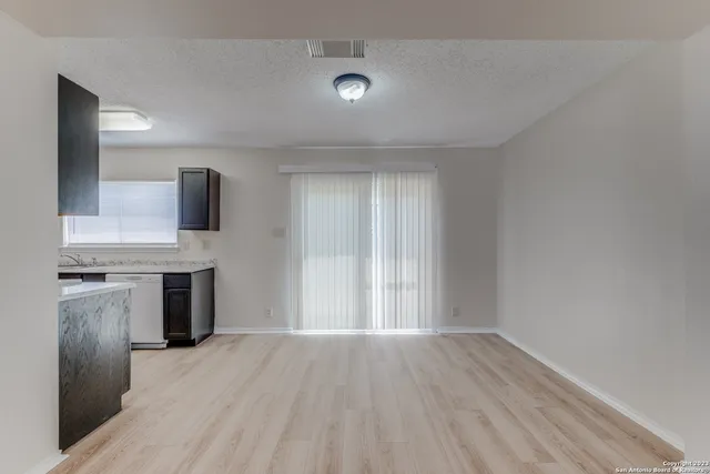 a view of a kitchen with a sink and dishwasher wooden floor